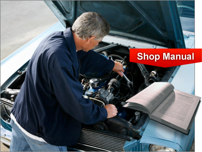 Man working on classic car with open shop manual